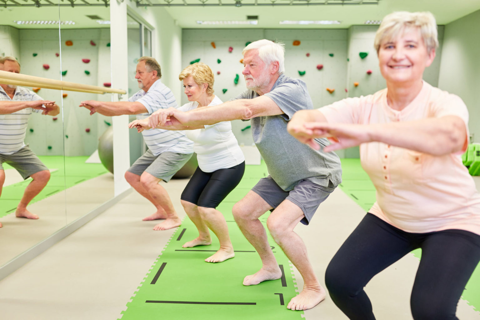 Group of vital seniors doing squats - Bodytrack